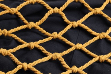 Photo of Handmade macrame shopping bag as background, closeup