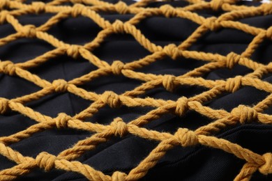 Photo of Handmade macrame shopping bag as background, closeup