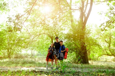 Photo of Happy family travelling together in beautiful forest