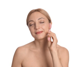 Photo of Beautiful woman doing facial self massage with roller on white background