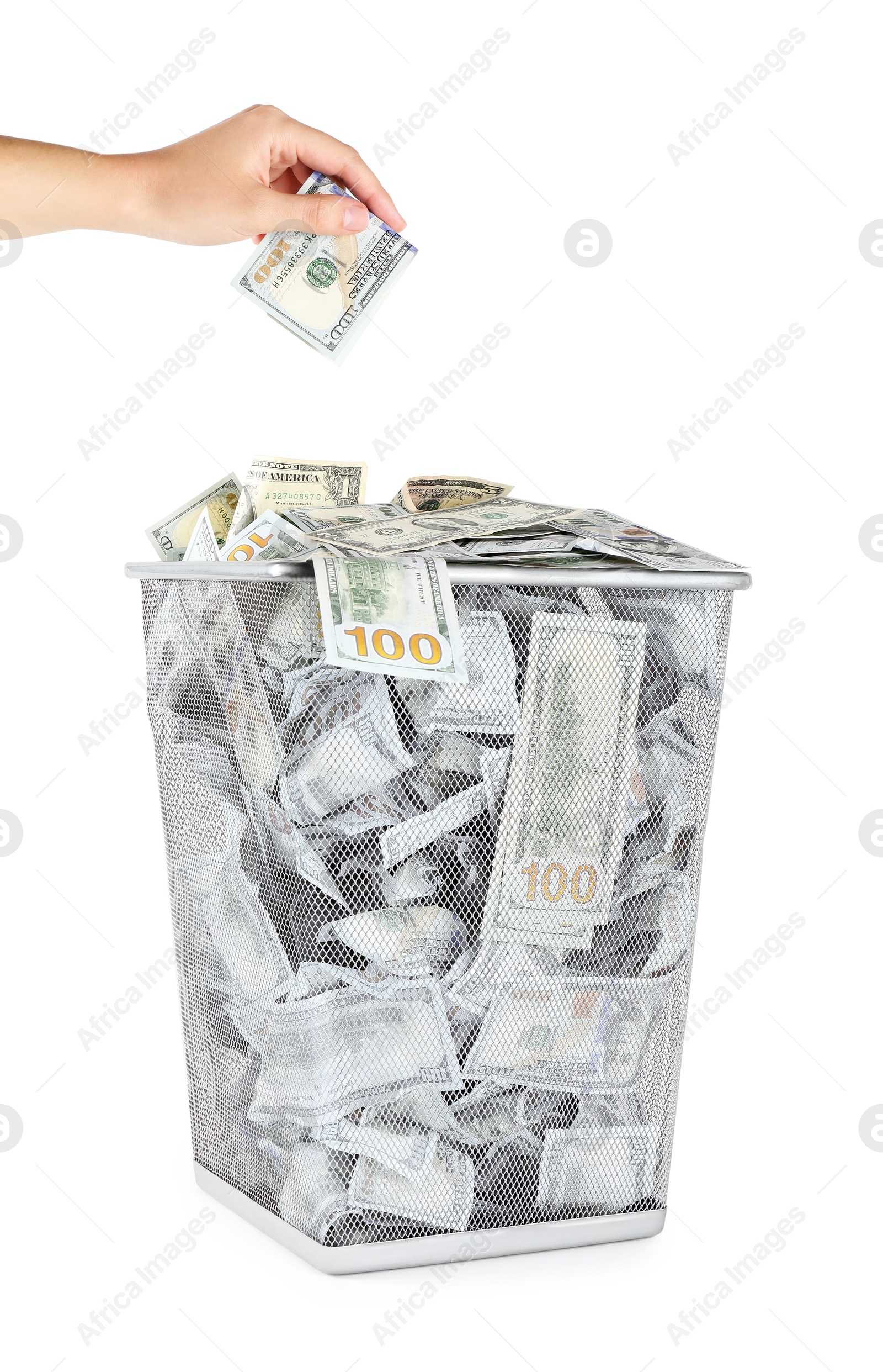 Photo of Woman throwing dollar banknote into trash bin on white background, closeup