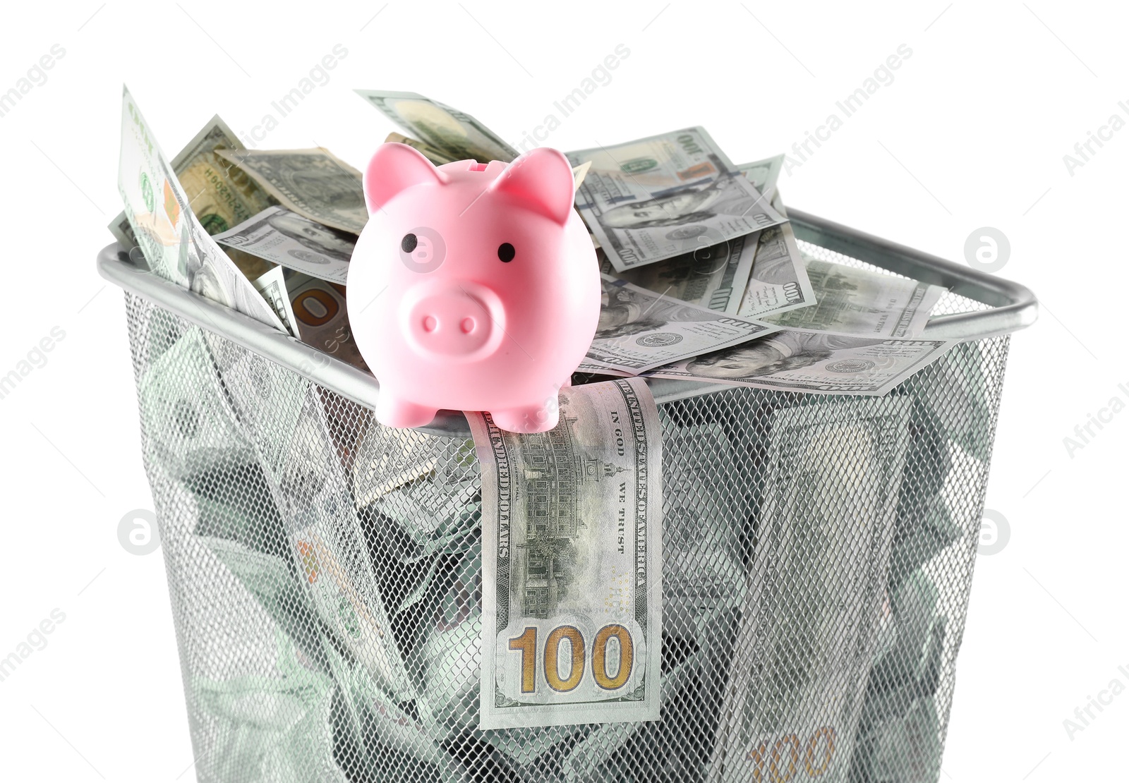 Photo of Many dollar banknotes and piggy bank in trash bin isolated on white