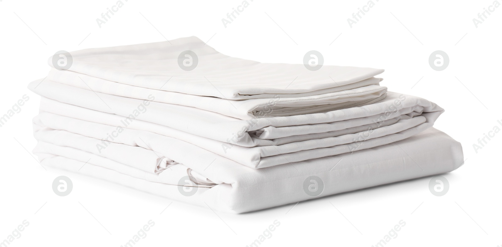 Photo of Stacked clean bed linens on white background