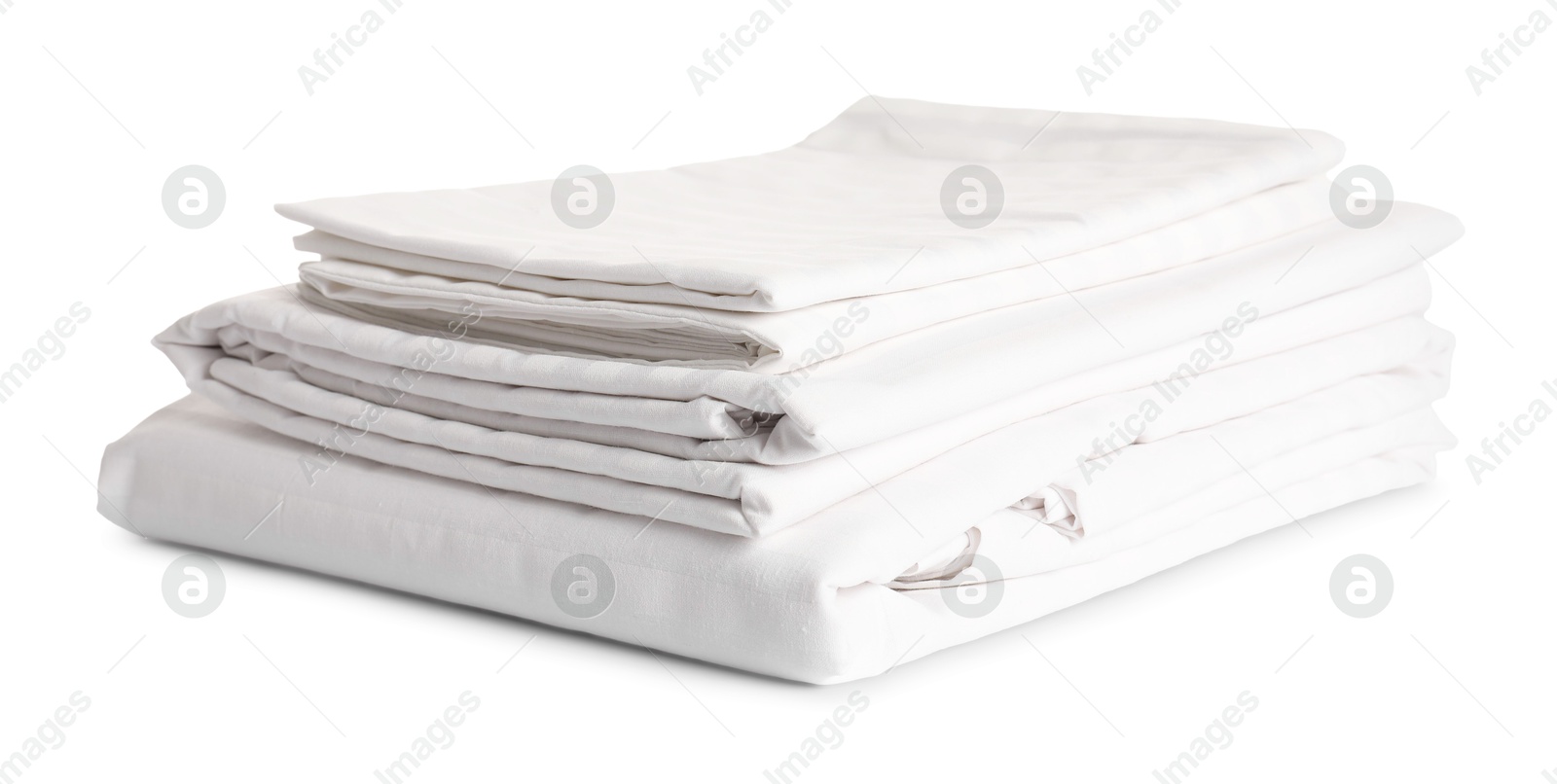 Photo of Stacked clean bed linens on white background