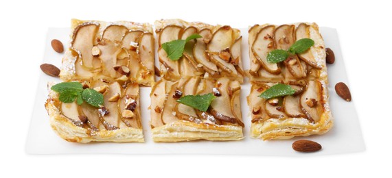 Photo of Pieces of tasty puff pastry pie with pears, mint and almonds isolated on white