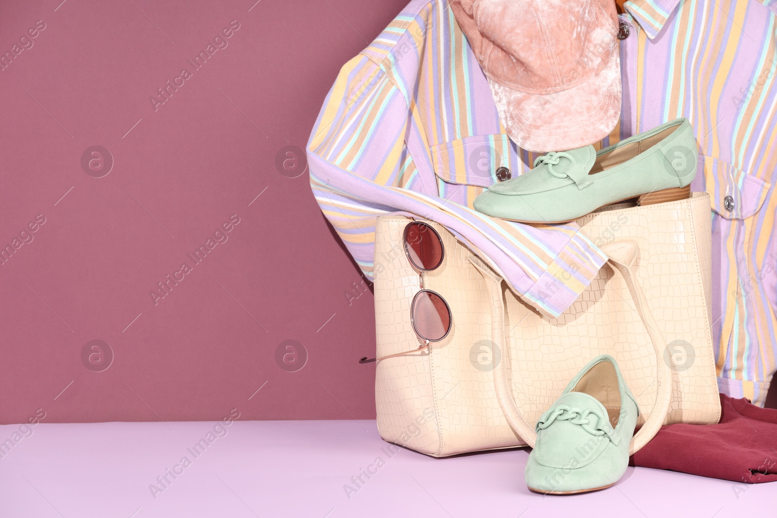 Photo of Clothes, shoes, bag and sunglasses on color background, space for text