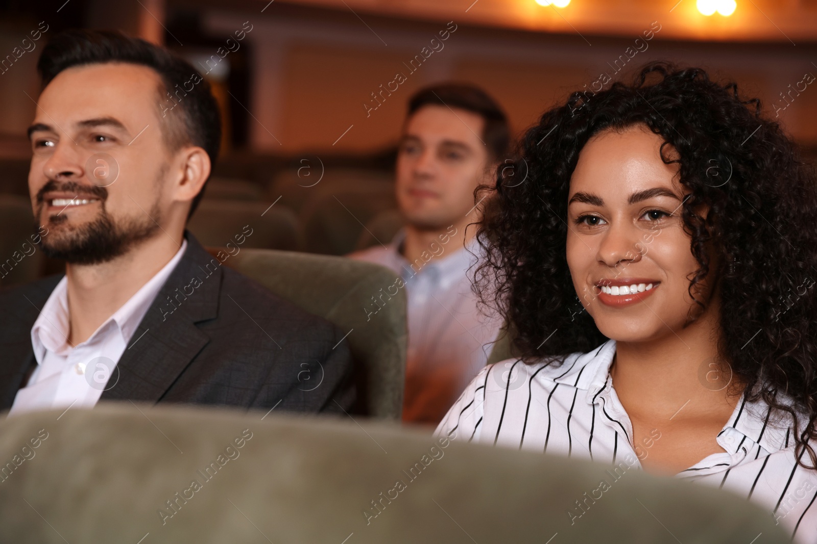 Photo of Group of people watching theatrical performance in theatre