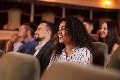 Group of people watching theatrical performance in theatre