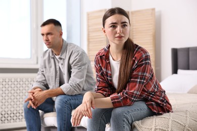 Photo of Offended couple ignoring each other at home