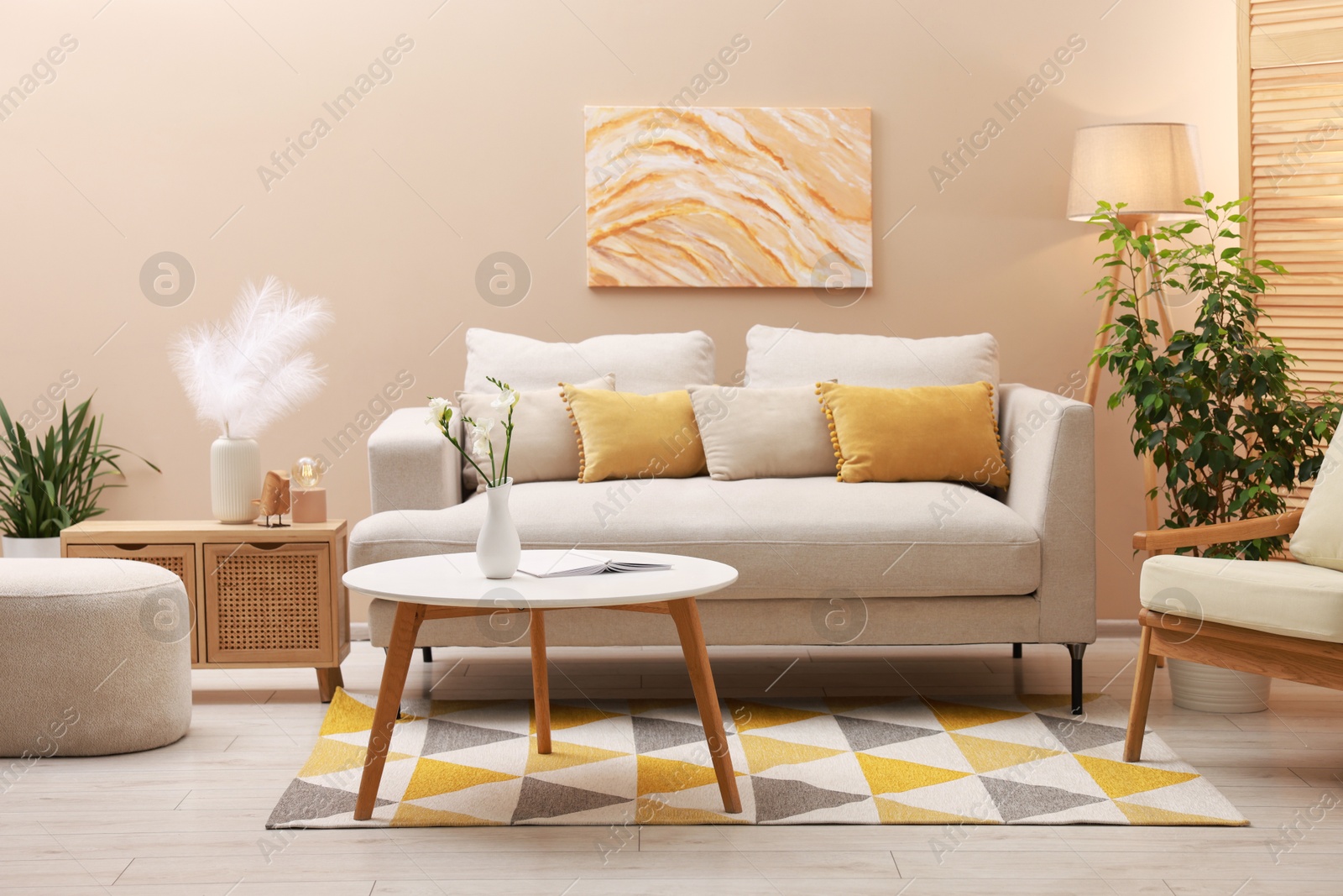 Photo of Stylish living room interior with comfortable sofa near beige wall