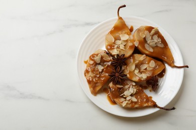 Photo of Delicious pears with caramel sauce, almond flakes and anise stars on white marble table, top view. Space for text