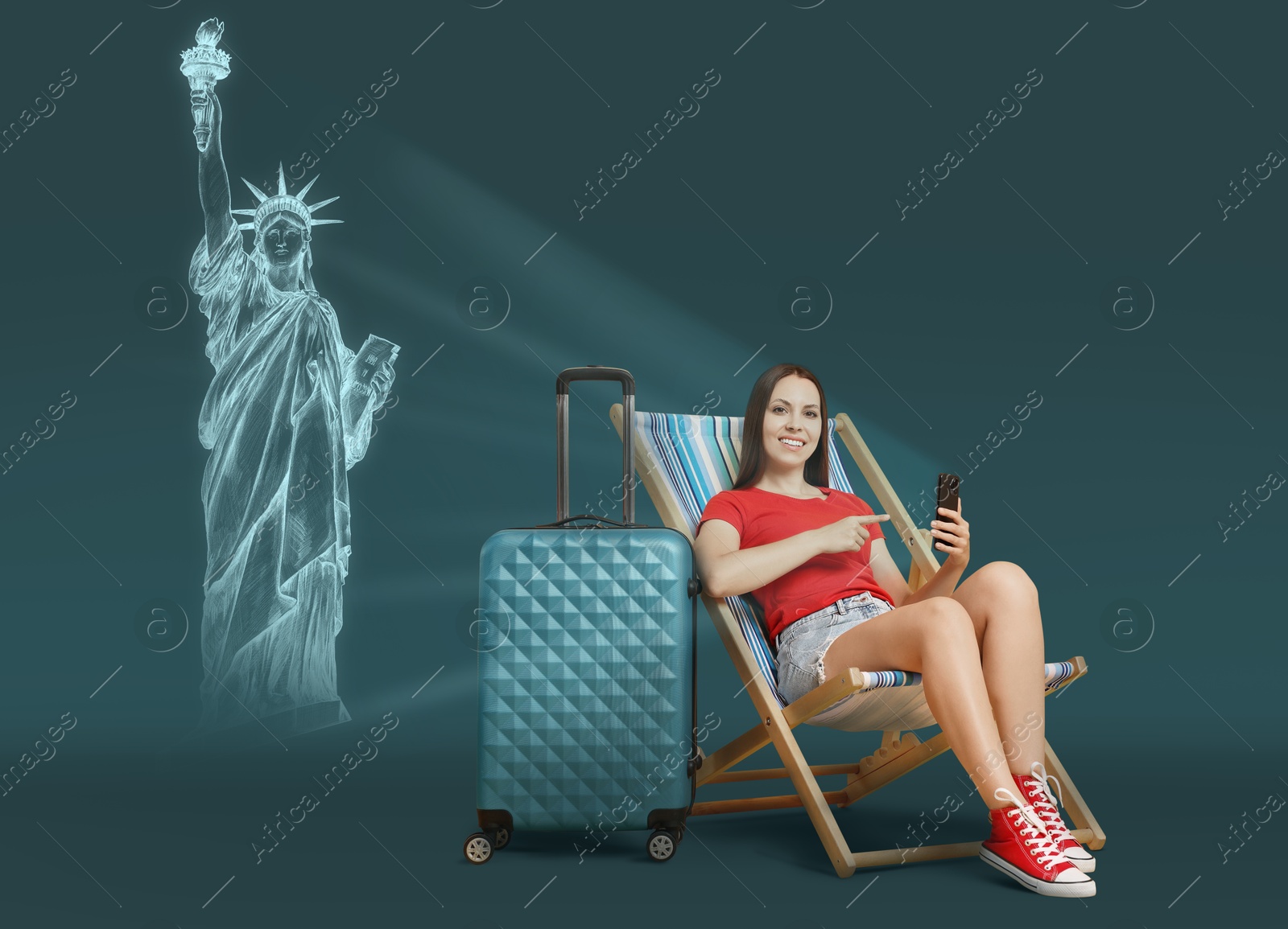 Image of Happy traveler with suitcase sitting on deckchair against dark background. Woman using mobile phone. Illustration of Statue of Liberty behind her