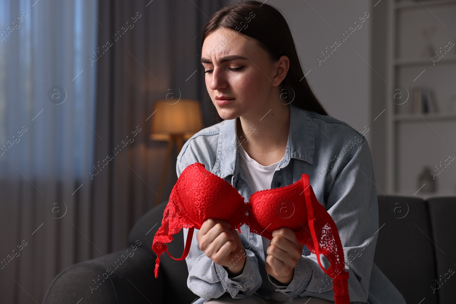 Photo of Frustrated wife with mistress bra alone at home. Space for text