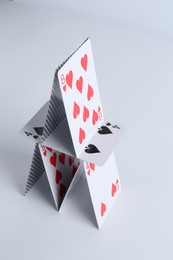 House of playing cards on white background