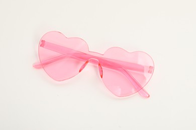 Photo of Stylish heart shaped sunglasses on white background