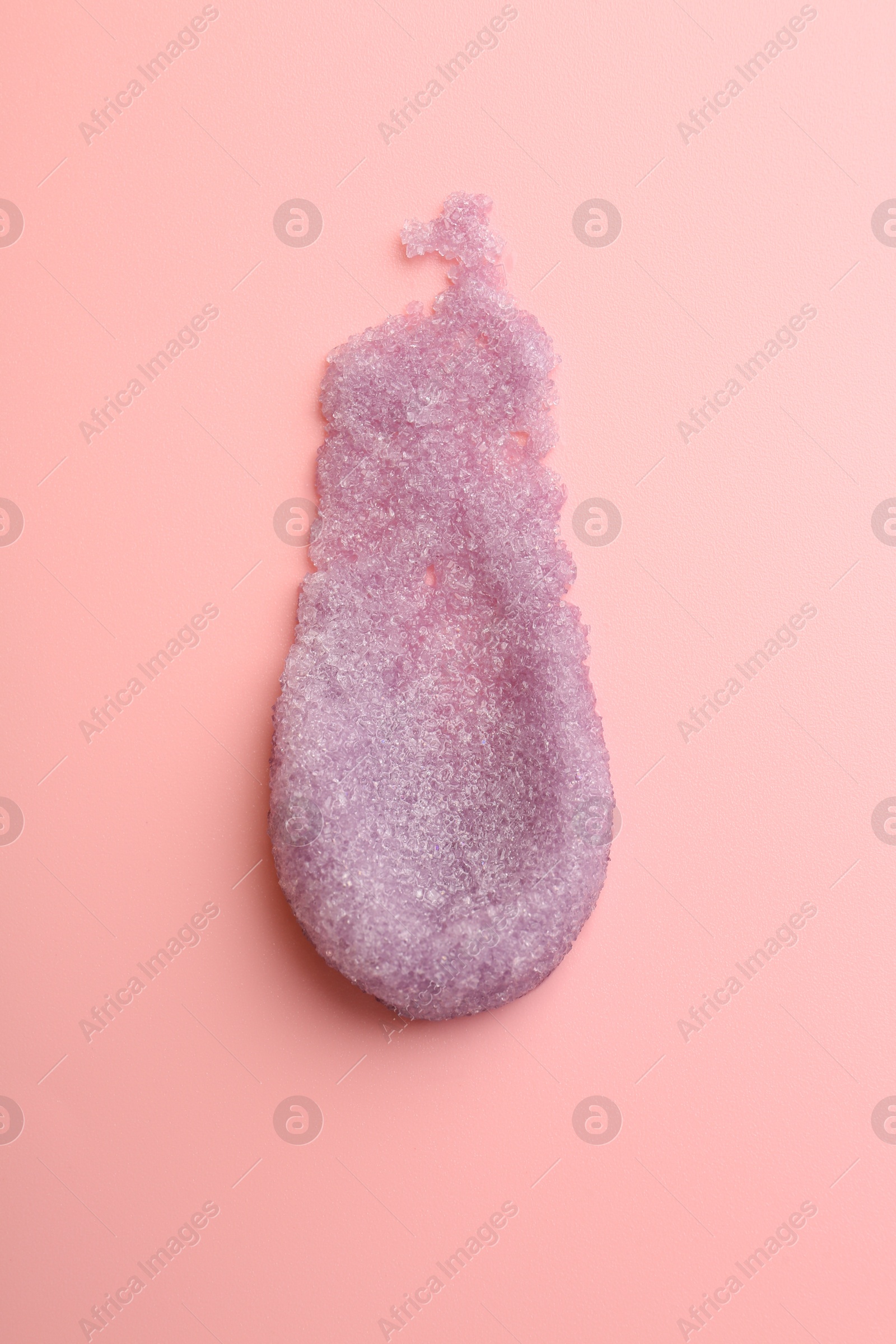 Photo of Smear of body scrub on light pink background, top view