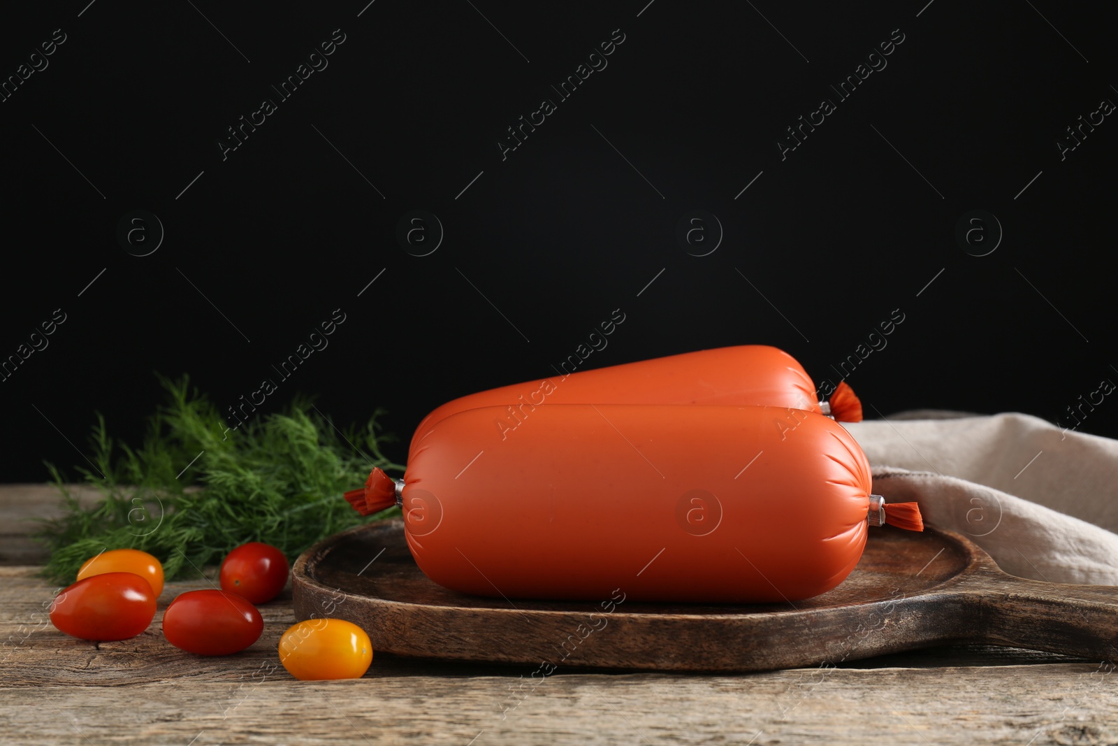 Photo of Tasty boiled sausages, tomatoes and dill on wooden table