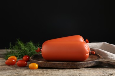 Photo of Tasty boiled sausages, tomatoes and dill on wooden table