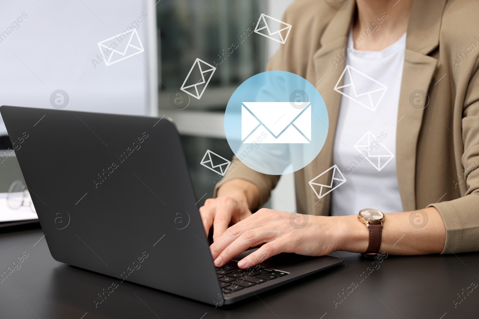 Image of Woman using laptop at table, closeup. Envelopes as symbol of message over computer