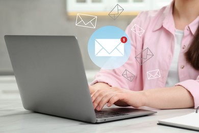 Image of Woman using laptop at table, closeup. Envelopes as symbol of message over computer