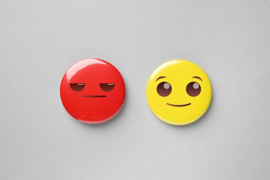 Image of Badges with displeased and smiling faces on grey background