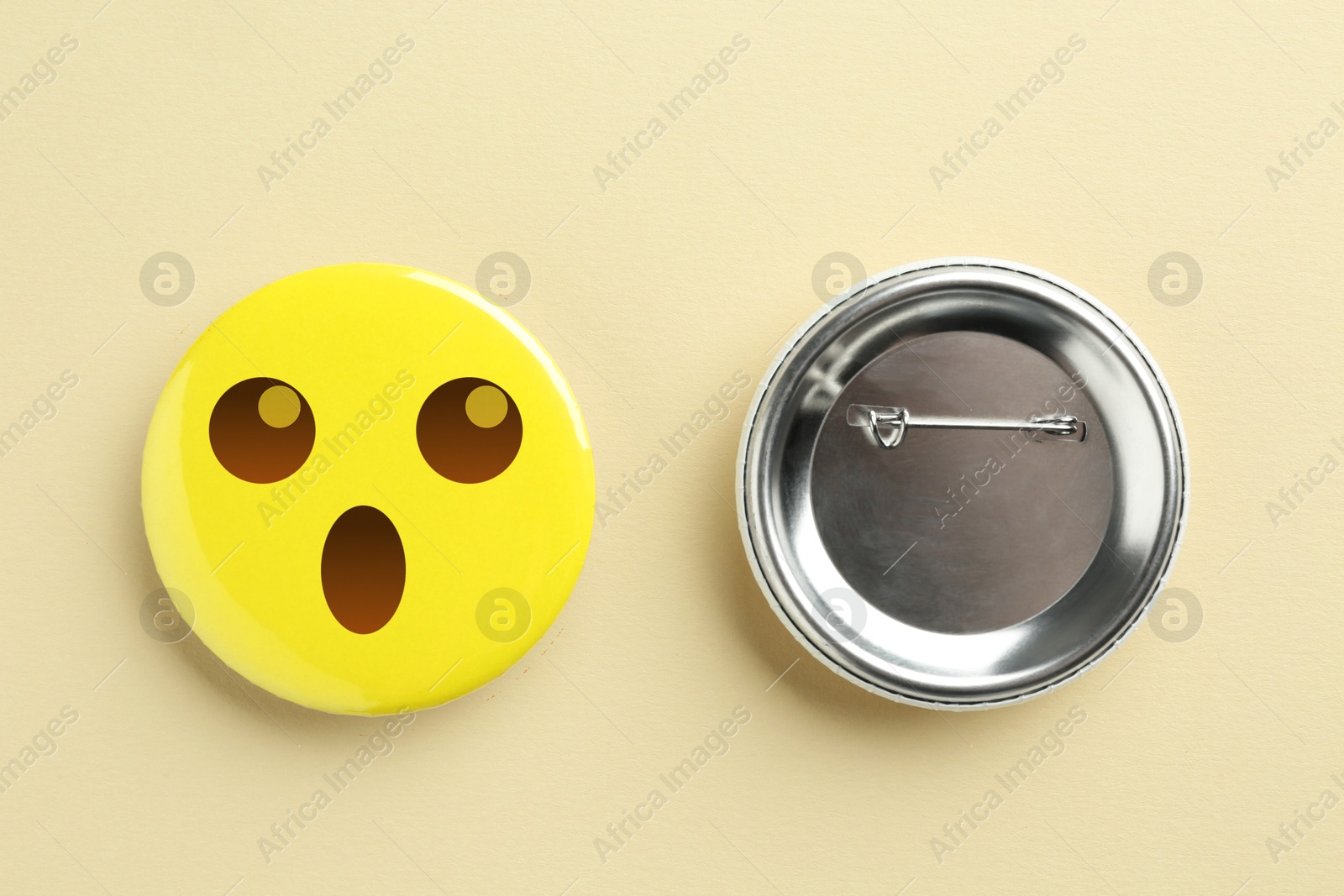 Image of Badges on beige background. One with shocked or surprised face