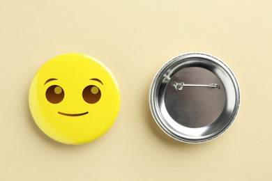 Image of Badges on beige background. One with smiling face