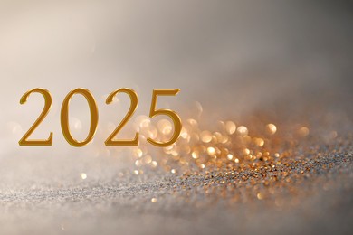 Image of 2025 New Year greeting card with golden sparkles