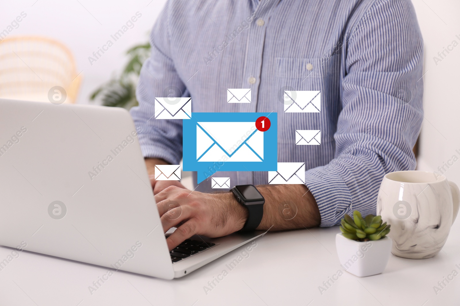 Image of Man using laptop at table, closeup. Envelopes as symbol of message over computer