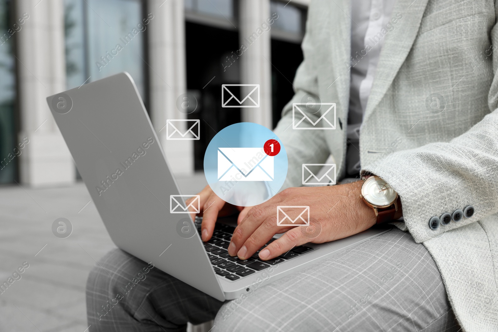 Image of Man using laptop outdoors, closeup. Envelopes as symbol of message over computer