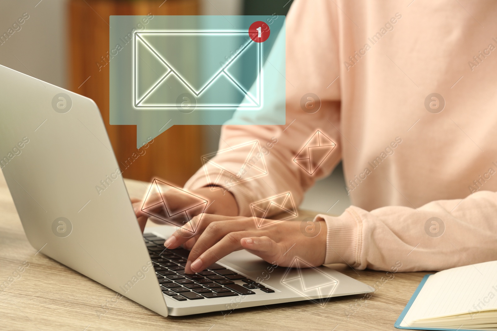 Image of Woman using laptop at table, closeup. Envelopes as symbol of message over computer