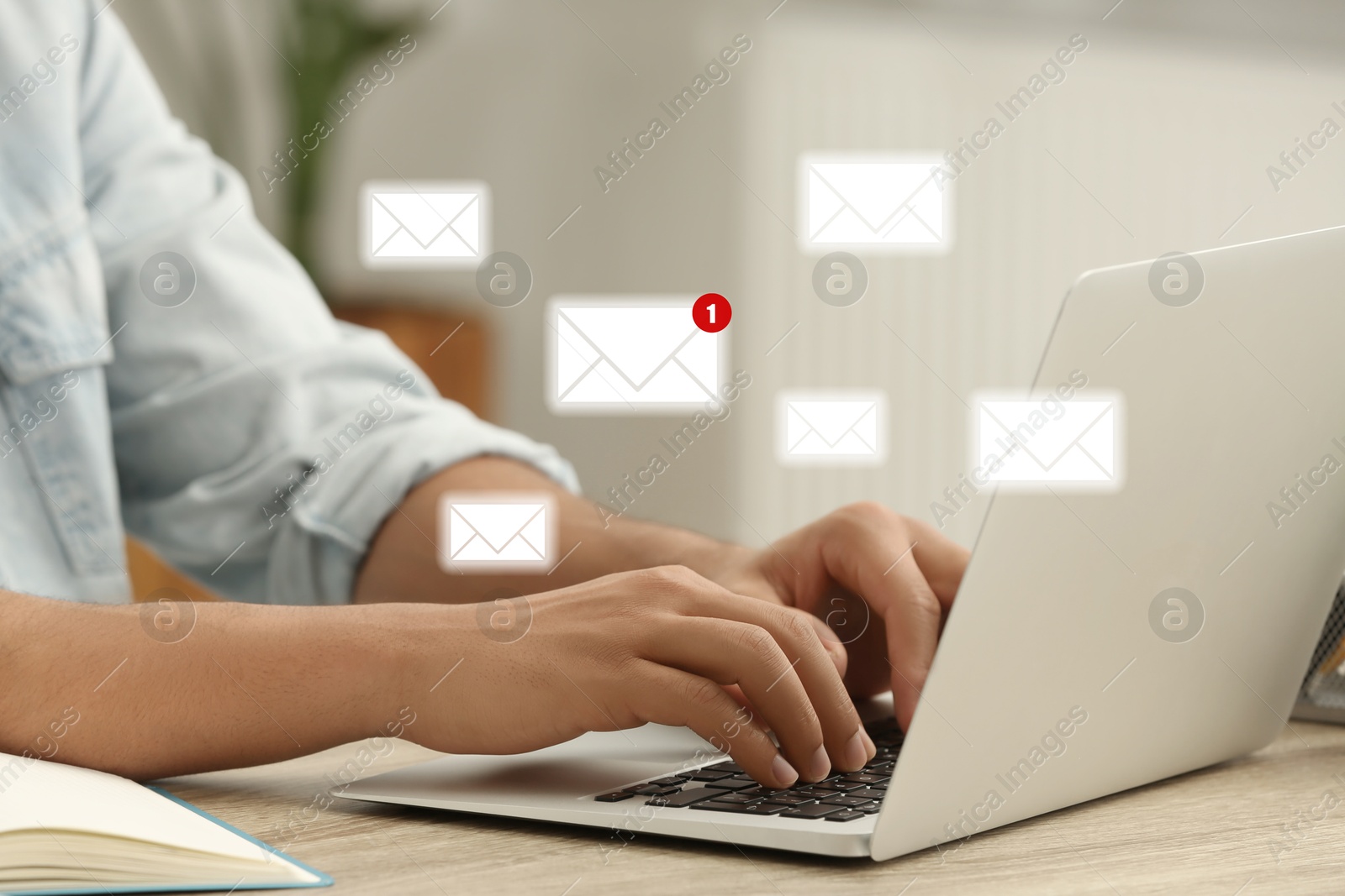 Image of Woman using laptop at table, closeup. Envelopes as symbol of message over computer