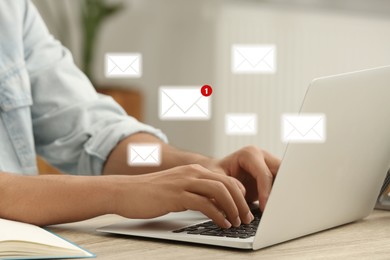 Image of Woman using laptop at table, closeup. Envelopes as symbol of message over computer