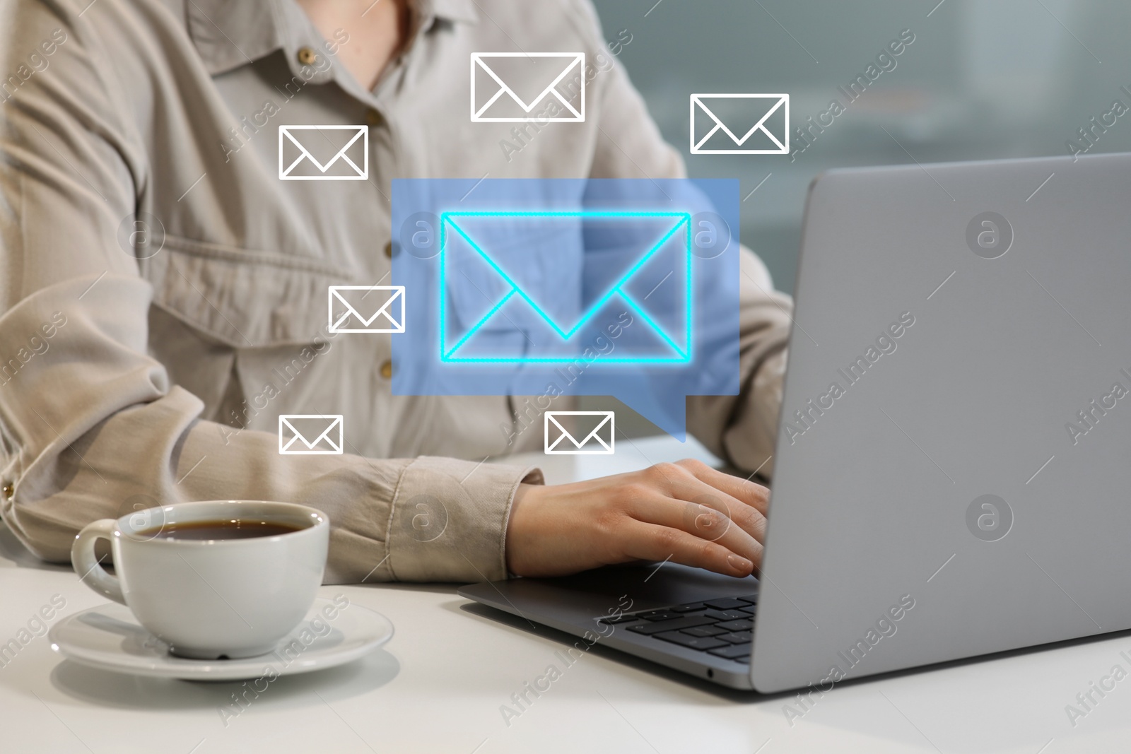 Image of Woman using laptop at table, closeup. Envelopes as symbol of message over computer