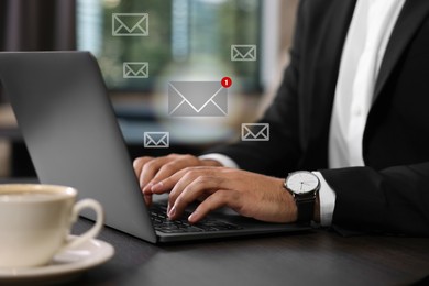 Man using laptop at table, closeup. Envelopes as symbol of message over computer