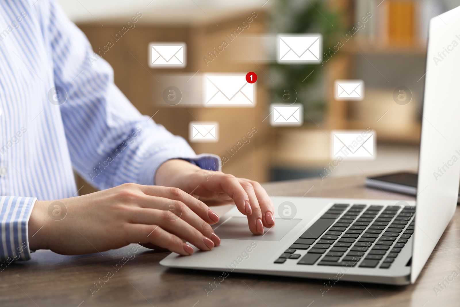 Image of Woman using laptop at table, closeup. Envelopes as symbol of message over computer