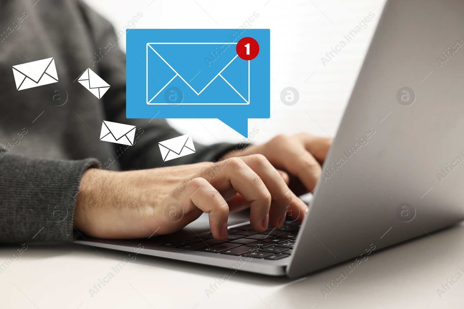 Image of Man using laptop at table, closeup. Envelopes as symbol of message over computer