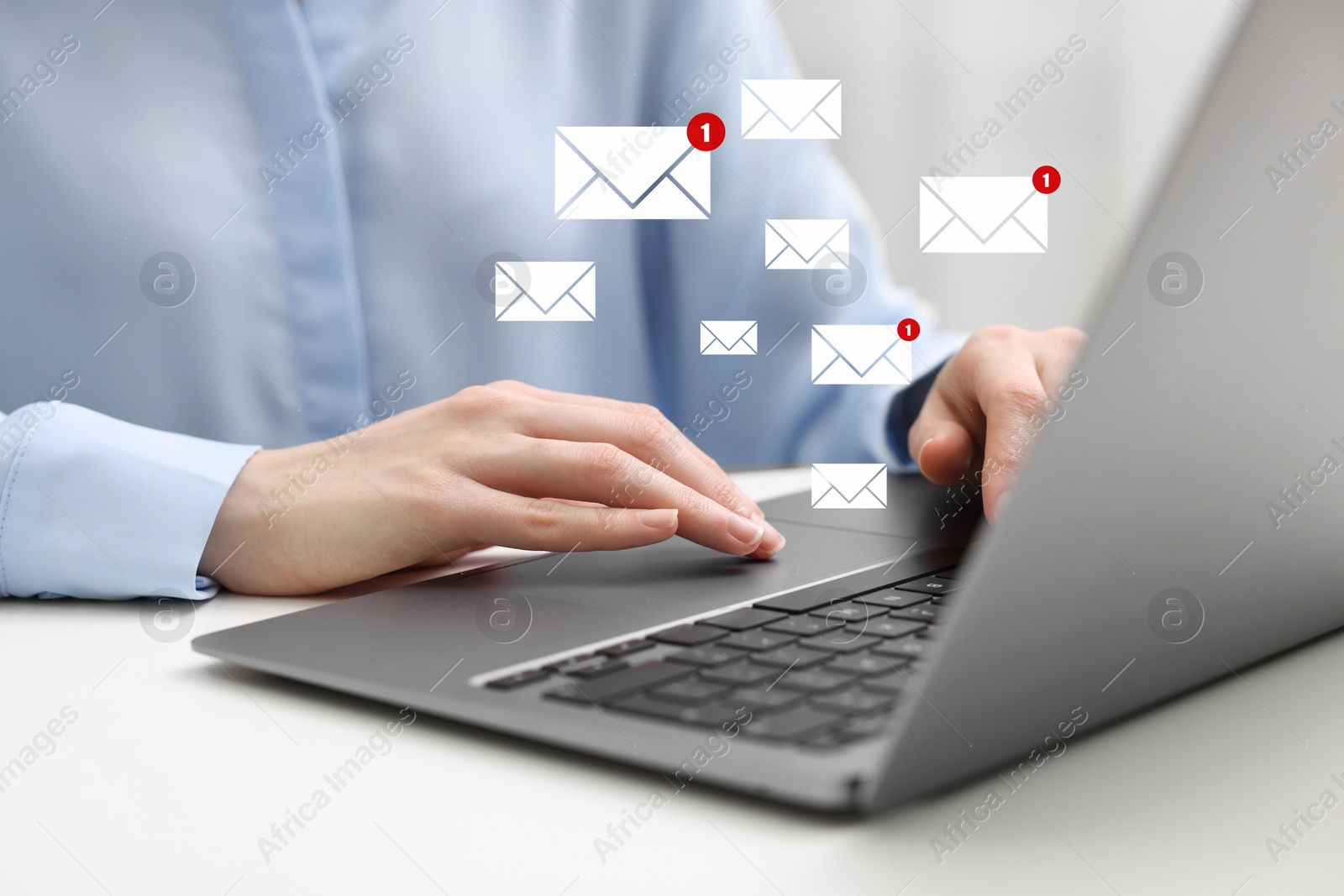 Image of Woman using laptop at table, closeup. Envelopes as symbol of message over computer