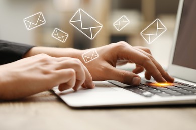 Man using laptop at table, closeup. Envelopes as symbol of message over computer