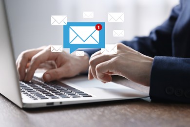 Image of Man using laptop at table, closeup. Envelopes as symbol of message over computer