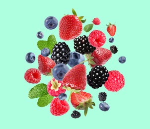 Image of Mix of fresh berries in air on turquoise background