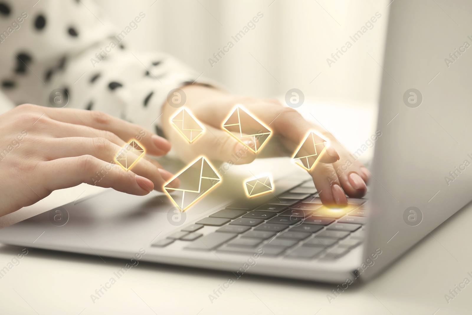 Image of Woman using laptop at table, closeup. Envelopes as symbol of message over computer