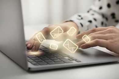 Image of Woman using laptop at table, closeup. Envelopes as symbol of message over computer