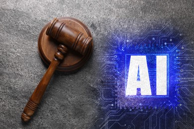 Image of Artificial intelligence and law. Judge's gavel and AI abbreviation on grey table