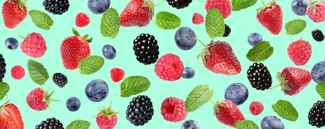 Image of Mix of fresh berries in air on turquoise background