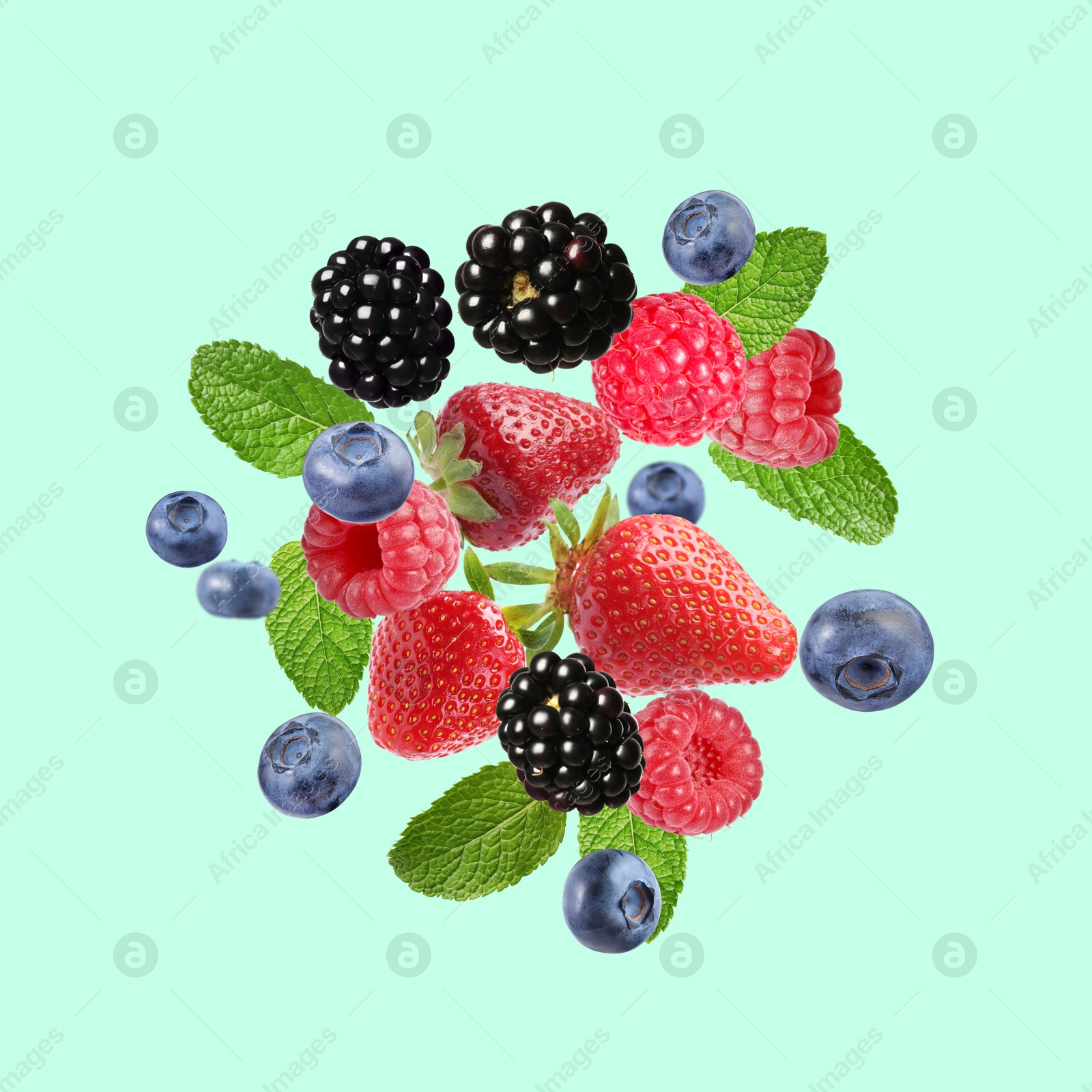 Image of Mix of fresh berries in air on turquoise background