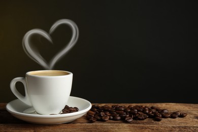 Image of Fresh aromatic coffee and beans on wooden table, space for text. Steam in shape of heart over cup