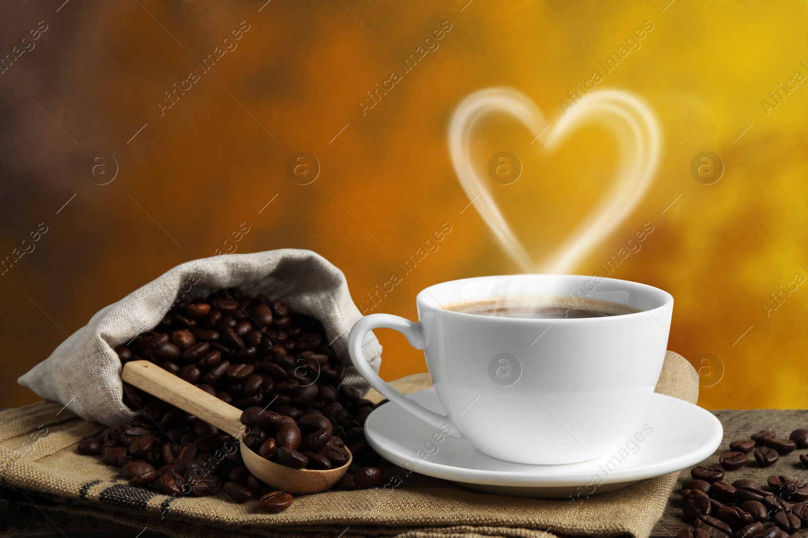 Image of Fresh aromatic coffee and beans on wooden table, space for text. Steam in shape of heart over cup