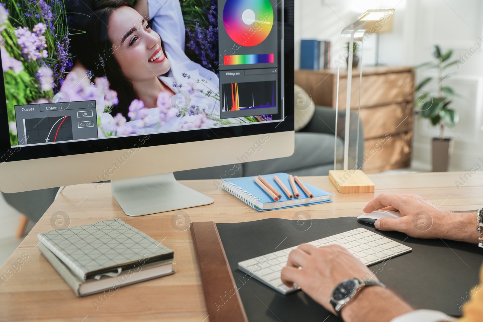 Photo of Professional retoucher working on computer at table, closeup