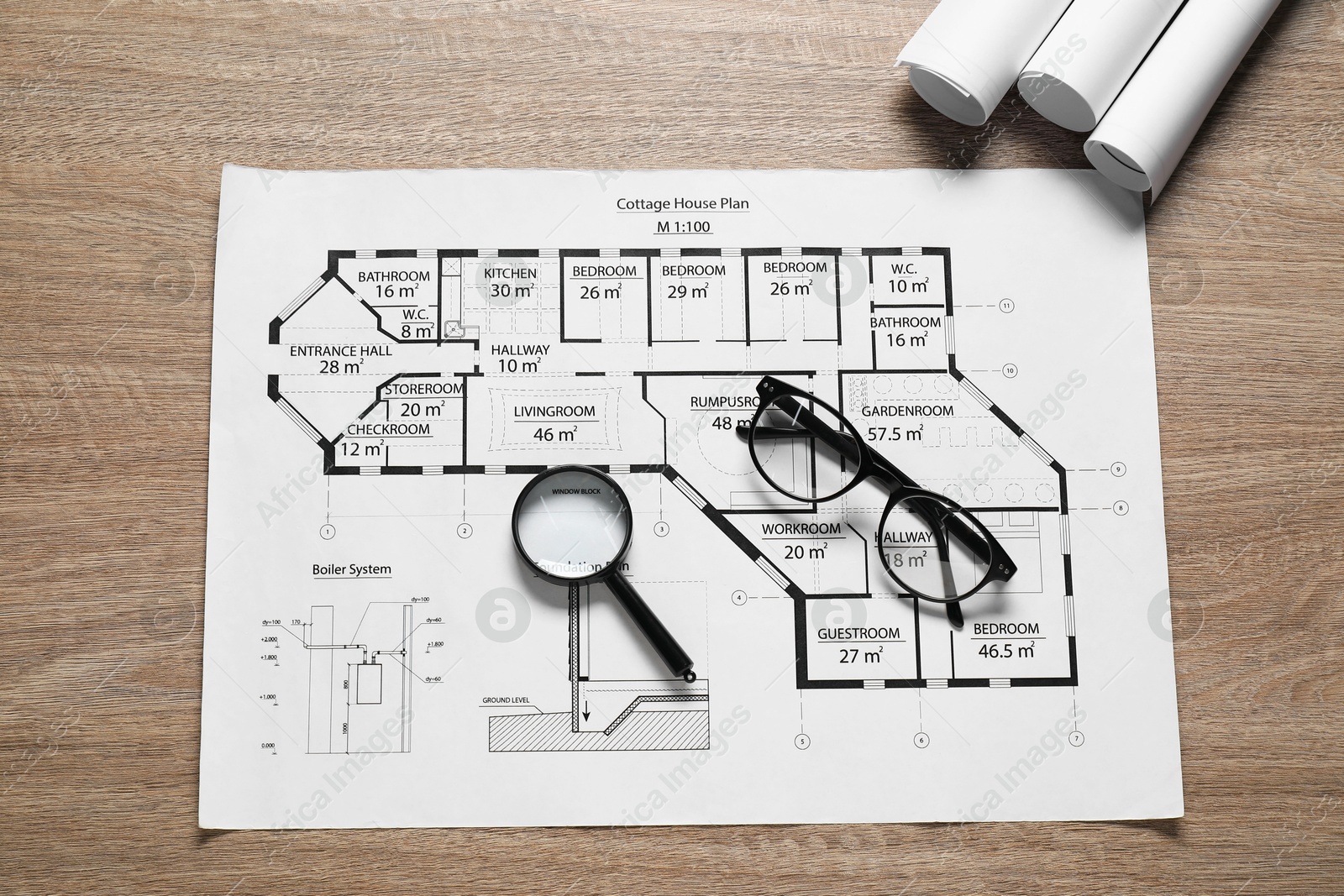 Photo of Different engineering drawings, glasses and magnifying glass on wooden table, top view